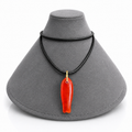 A red carved pendant necklace with a gold-colored loop and black cord, displayed on a gray jewelry bust against a white background.